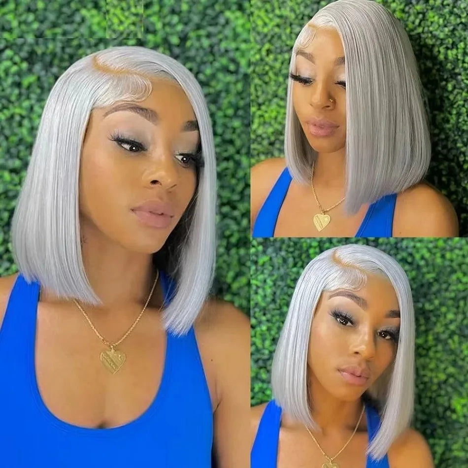Woman with silver bob haircut wearing a blue top against a green leafy background